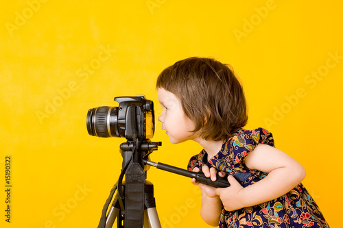 Baby girl holding photo camera