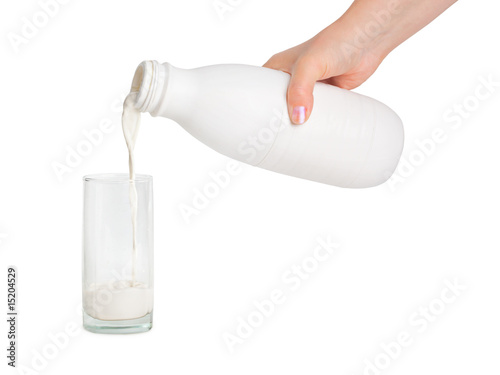 Hand with milk bottle and glass