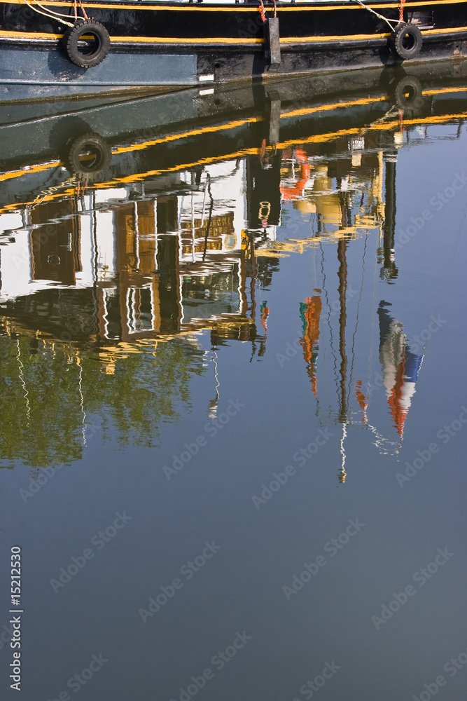 Reflection of part of ship with flags