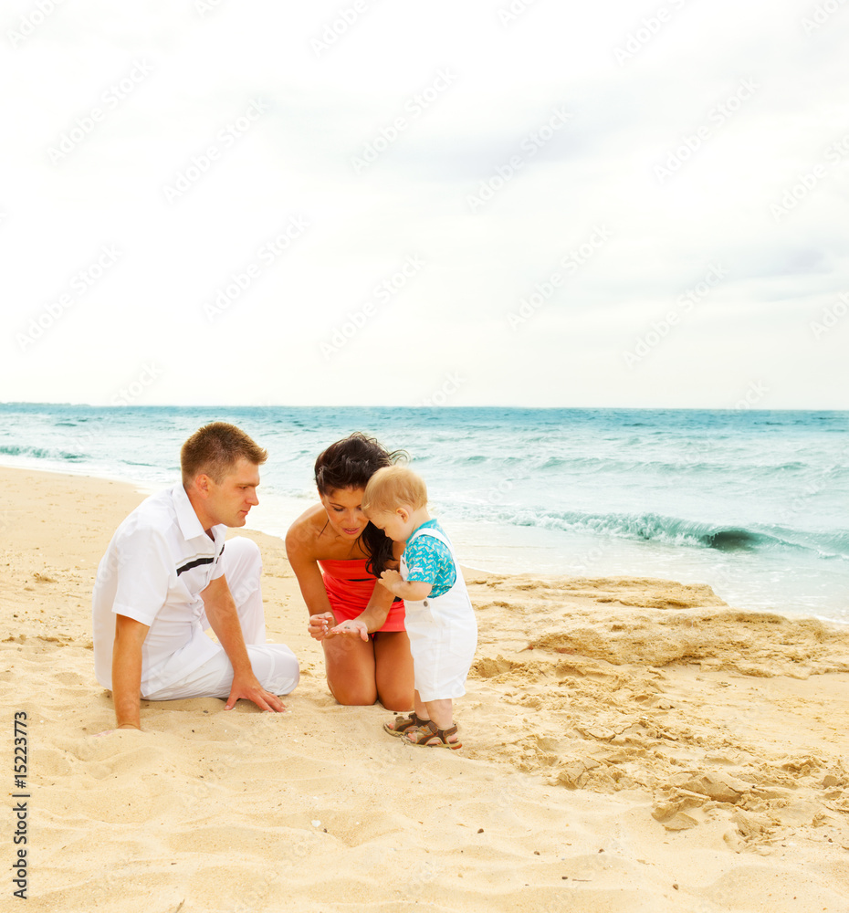 Family playing on the coastline