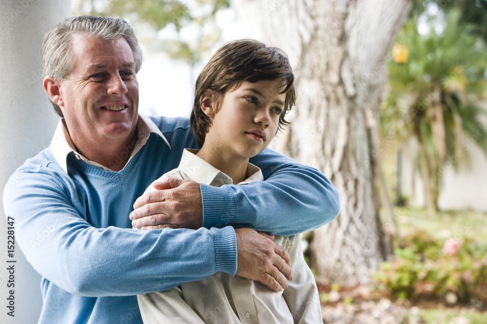 Affectionate father and son relaxing outdoors Affectionate father and son relaxing outdoors