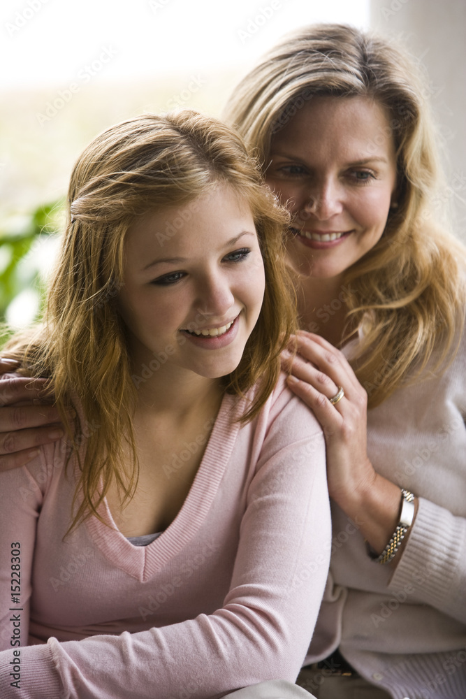 Fototapeta premium Portrait of smiling mature woman and teen girl