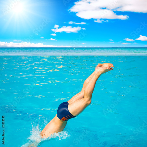 Man diving into blue water
