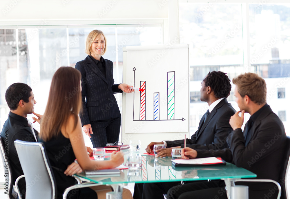 Businesswoman reporting to sales in a seminar Businesswoman reporting to sales in a seminar