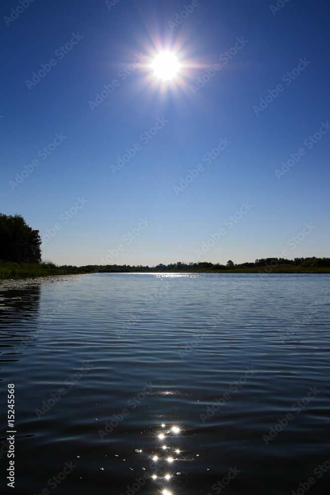 glowing sun over lake