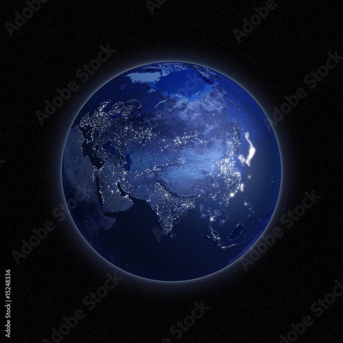 Night view of the Earth with lights glowing in urban areas.