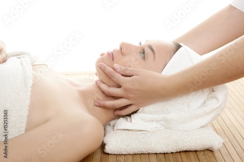 Beautiful woman face massage with white towel