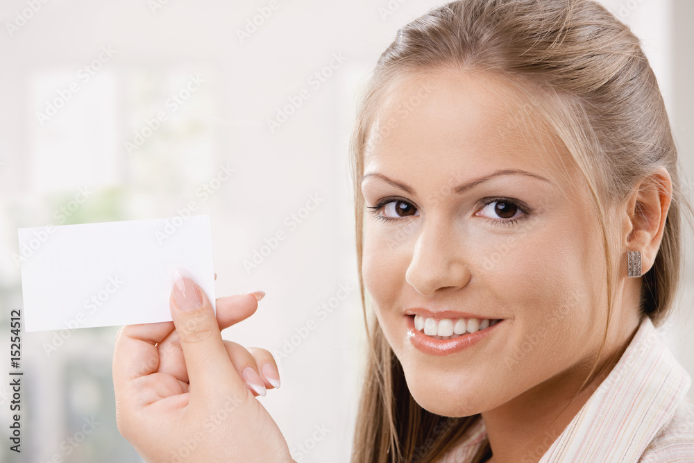Beautiful young woman holding card Beautiful young woman holding card