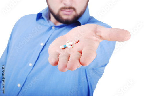 Isolated man offering medical pills