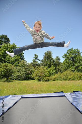 The young gymnast carries out jumps on a trampoline