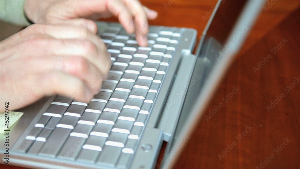 Man typing on laptop computer Man typing on laptop computer
