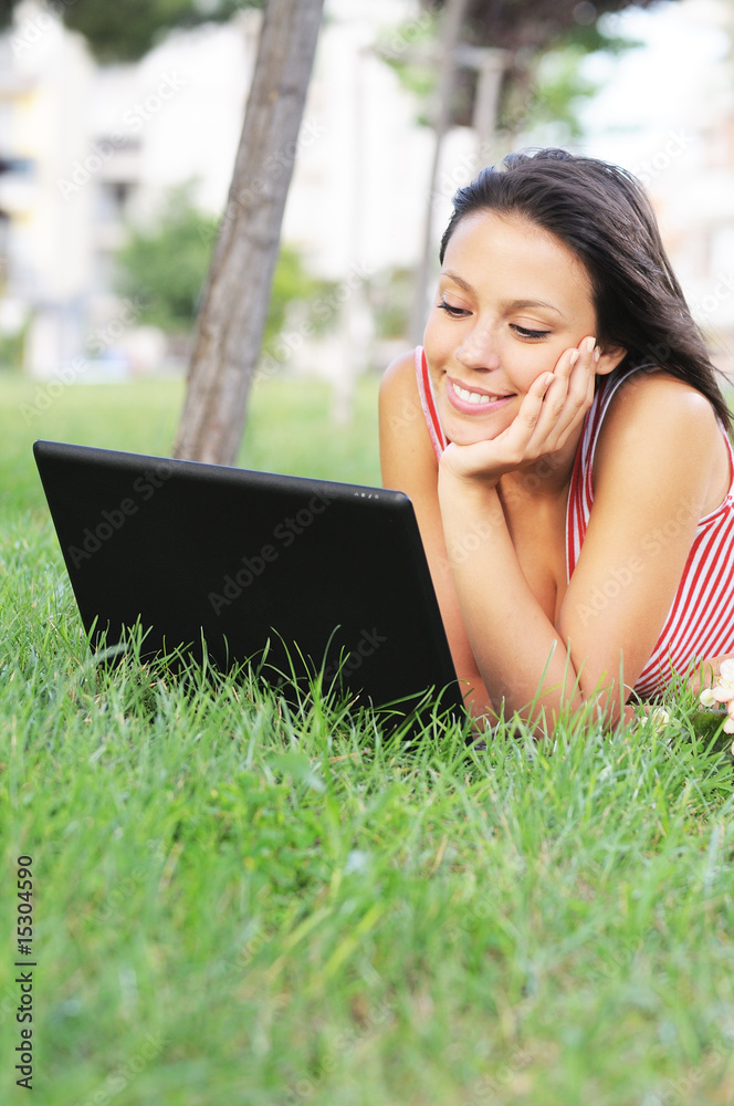 young woman and laptop in green park, entertainment and computer young woman and laptop in green park, entertainment and computer