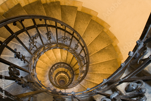 Spiral staircase, handrail and stone steps in ancient tower