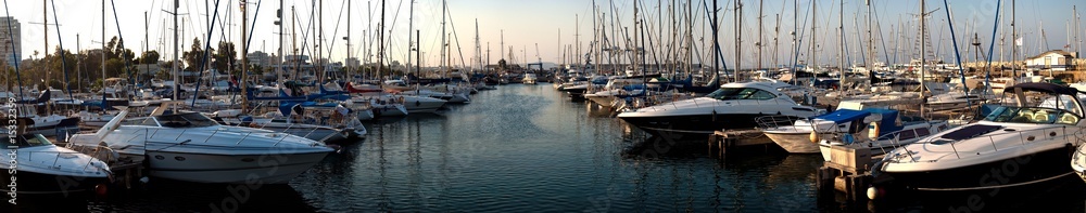 series of panoramic images from the harbor with yachts at dusk