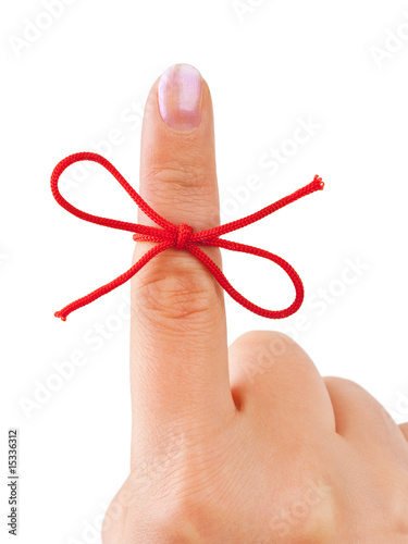 Red bow on finger