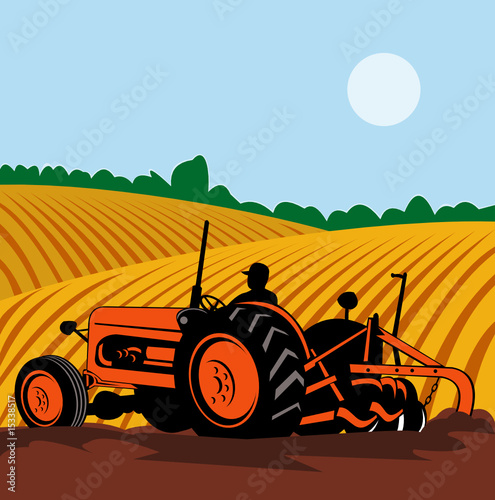 Farmer driving his tractor plowing the fields