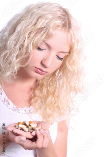 young blond woman taking tablet
