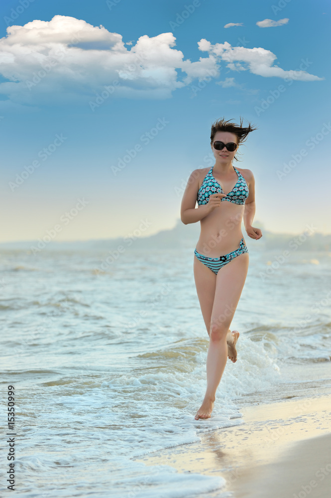 The girl running on seacoast
