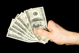 Money in a hand on a black background. (isolated)