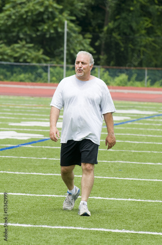 middle age man exercising on sports field