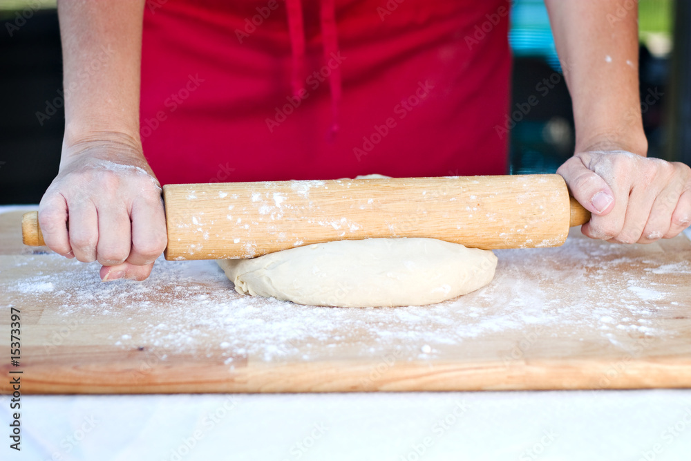 Woman hands rolling out dough