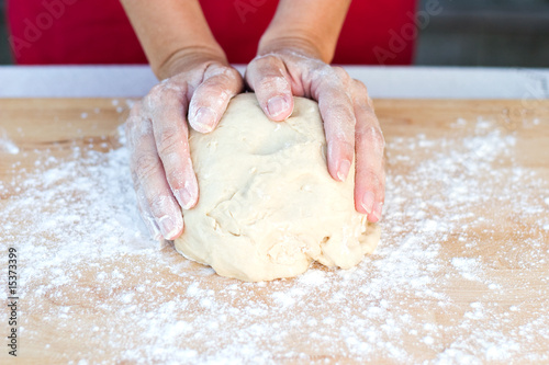 Woman hands kneading dough