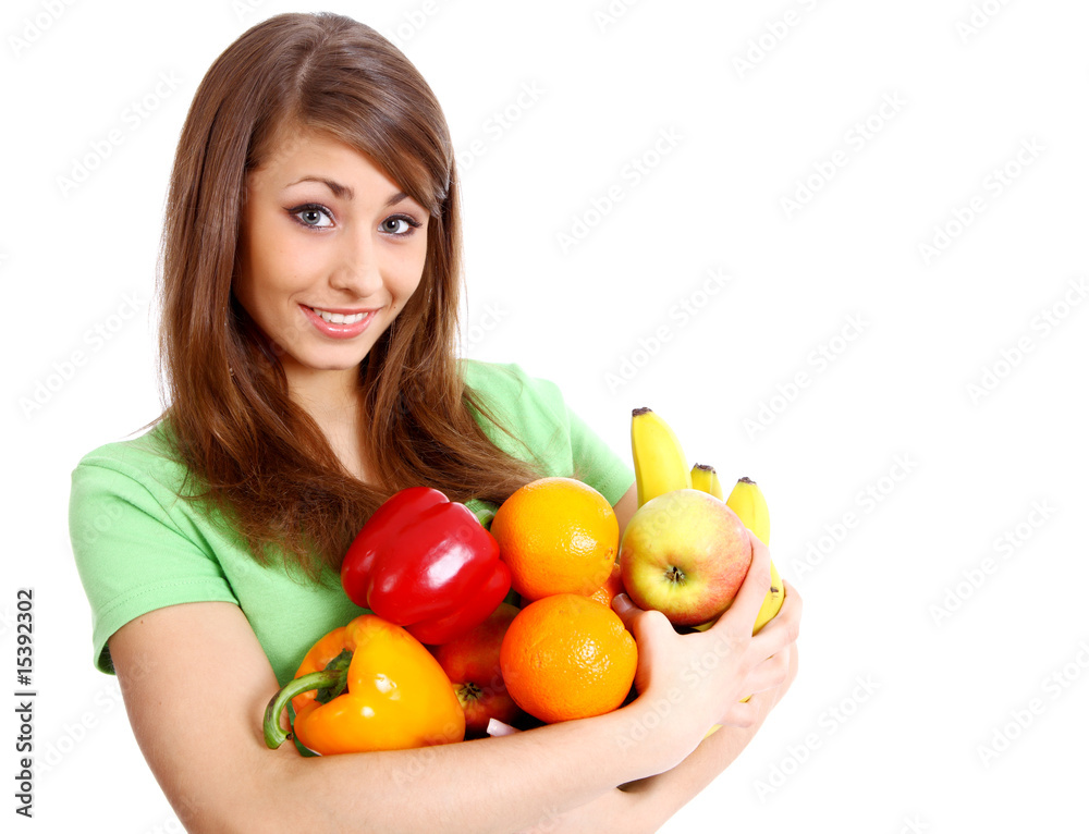 Portrait of a girl holding in hands full of different fruits and