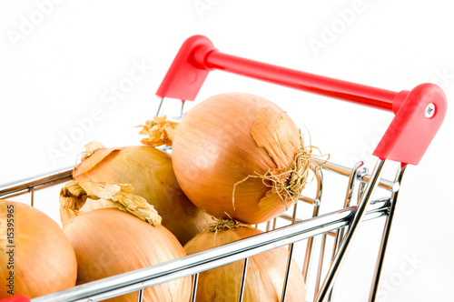 shopping cart with onions isolated on white background photo