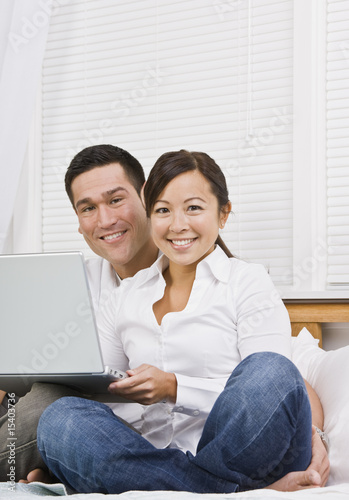 Asian couple with laptop © AVAVA