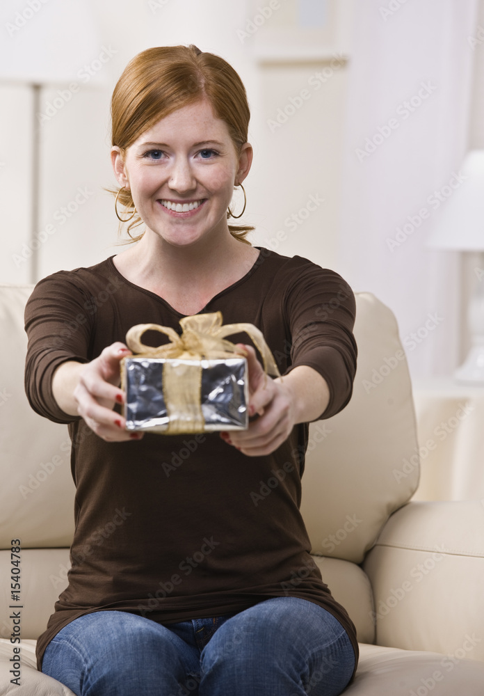 Woman Presenting Gift to the Camera