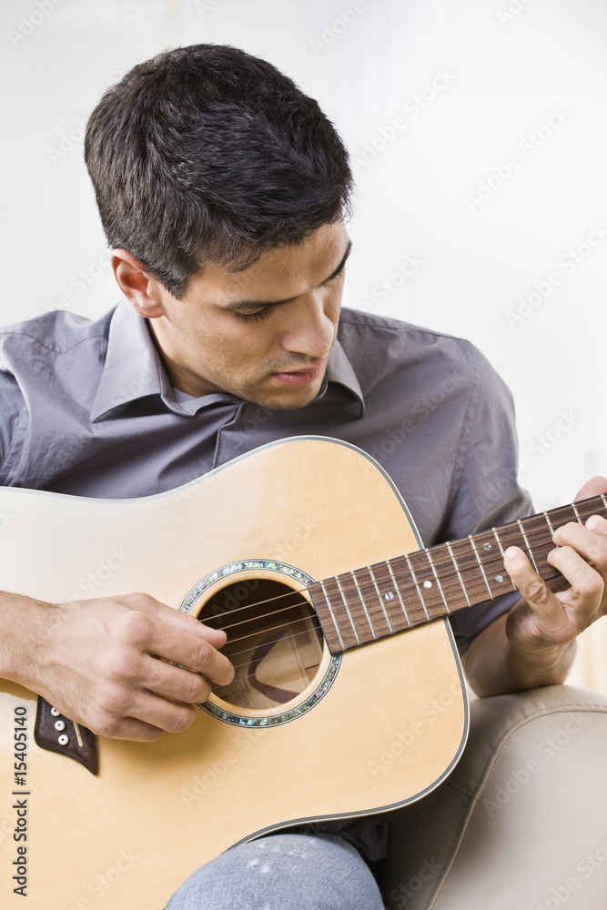 Man Playing an Acoustic Guitar