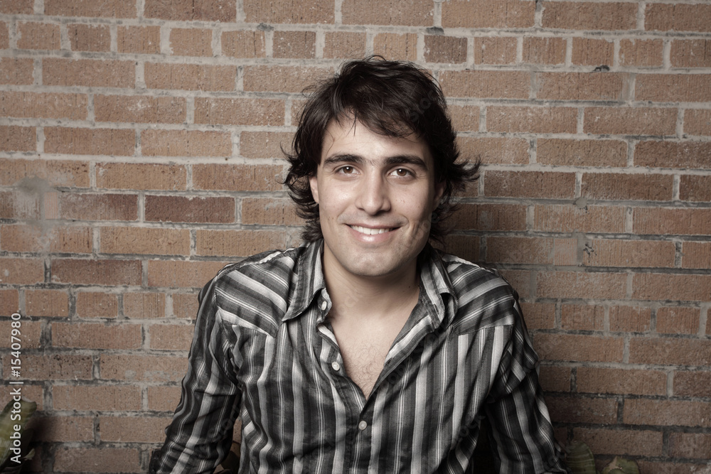 Handsome man on a brick wall Handsome man on a brick wall