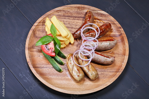 Assortment of grilled sausages with fresh vegetables