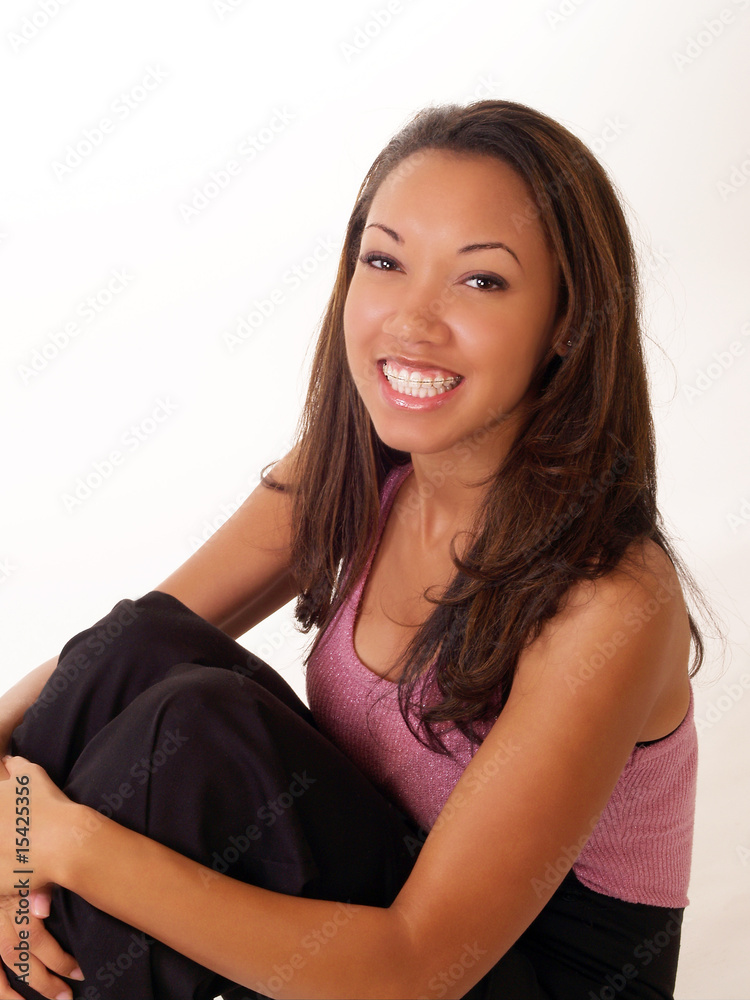 Smiling black woman with braces on upper teeth Smiling black woman with braces on upper teeth
