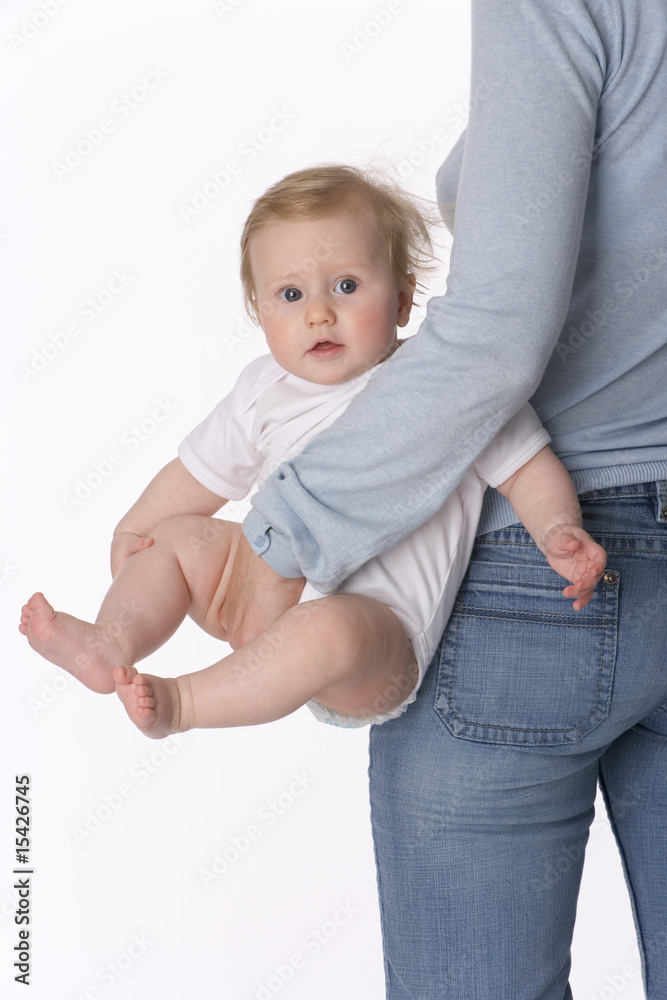 Baby girl is carried by her parent Baby girl is carried by her parent