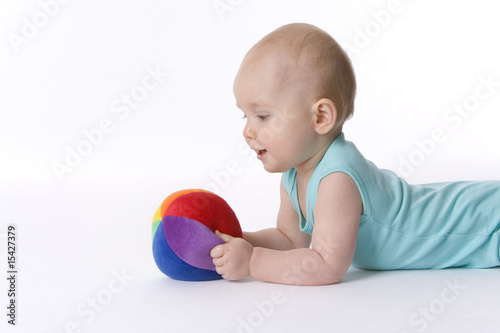 Baby boy with a soft colred toy ball photo