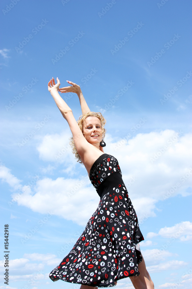 Portrait of the young girl on a background blue the sky