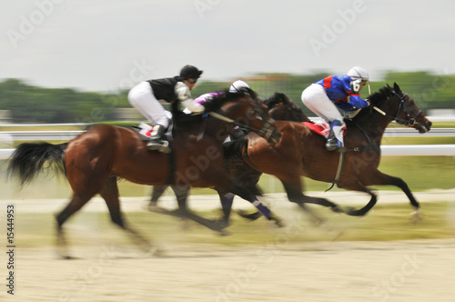 Obraz na plátně Slow shutter, racing jockeys and horses