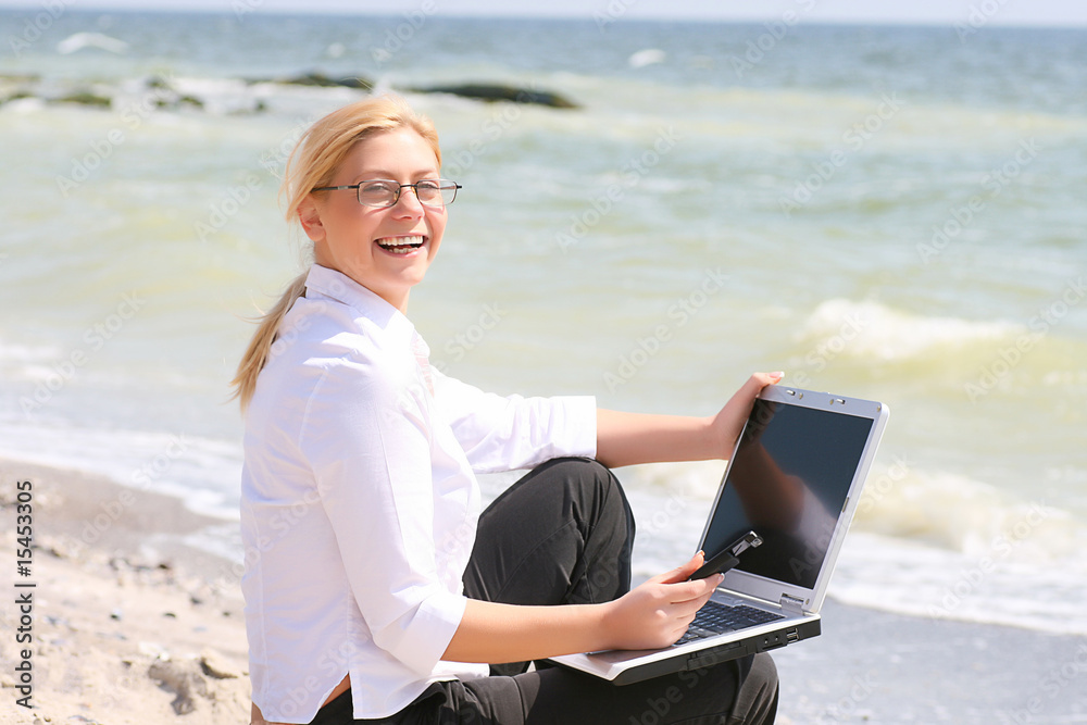 Businesswoman with business suit working on the beach