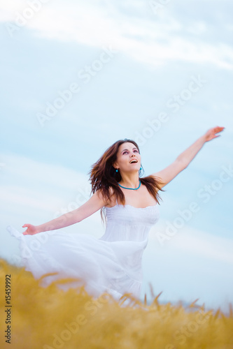 Girl dancing in wheat field