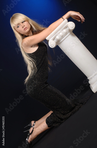 young woman kneeling next to the column photo