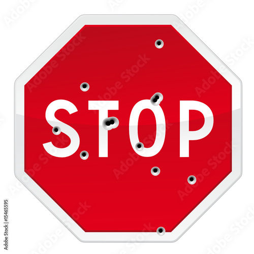 Stop road sign with bullets impacts