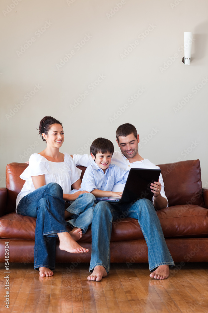 Parents and son playing with a laptop with copy-space Parents and son playing with a laptop with copy-space