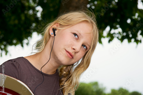 a girl with earphones look thoughtfully