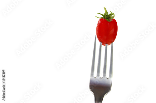 cherry tomato on a fork, isolated on white