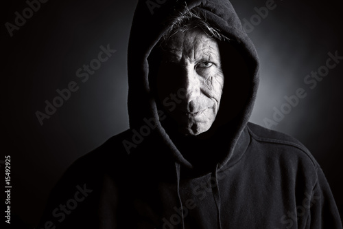 Low Key Shot of an Intimidating Senior Male in Hooded Top