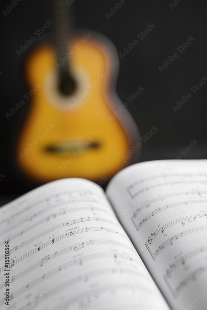 Fototapeta premium Musical chords and guitar on background