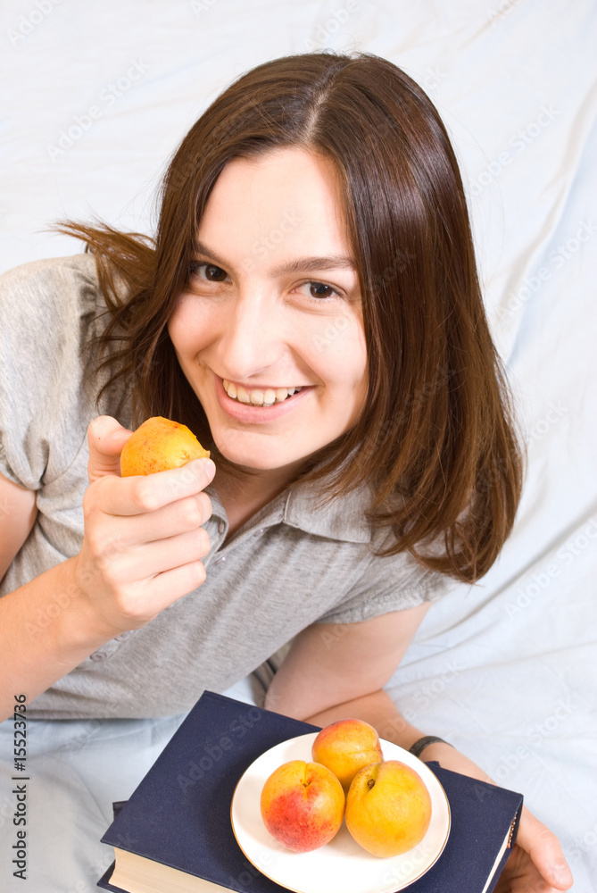 Portrait of young woman with peach Portrait of young woman with peach