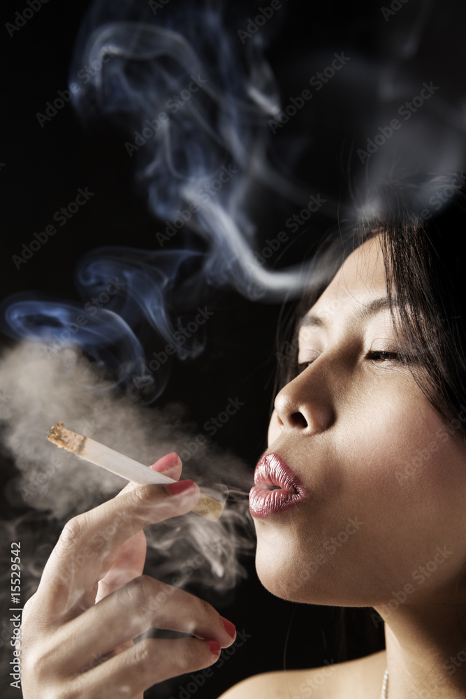 Fototapeta premium Female inhale smoke from cigarette