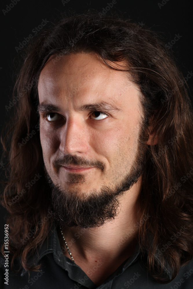 Portrait of guy with long hair and goatee looking up Portrait of guy with long hair and goatee looking up